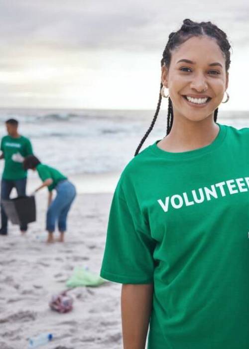 Cleaning, recycle and portrait of black woman at beach for plastic, environment or earth day. Recycling, sustainability and climate change with volunteer and trash for pollution and eco friendly